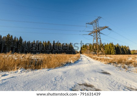 car tire tracks on winter road in deep snow in lonely forest