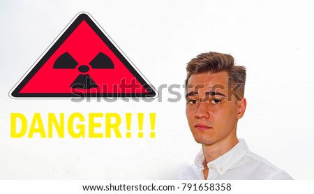 Portrait young men on a white background and the words danger. Sign danger radiation
