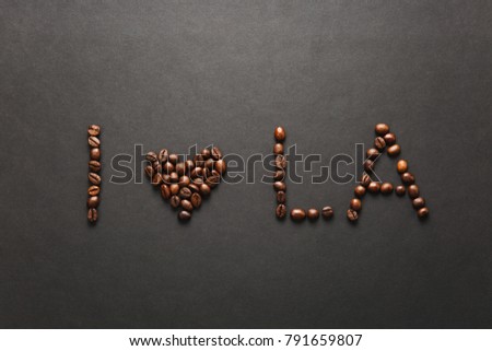 Top view of I love Los Angeles letter - I heart LA words made from coffee beans on black background for design. USA card on America, country state concept. Copy space for advertisement