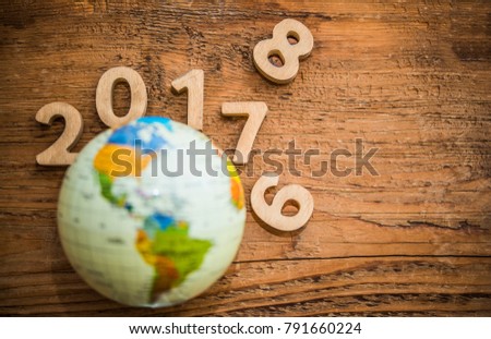 New year 2017, 2018, 2010 with round globe map lie on wooden table texture. Empty copy space for inscription or objects. old 2016 year
