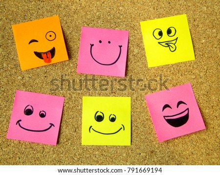 cork board with colorful post its representing various emoticons with various emotions communication concept