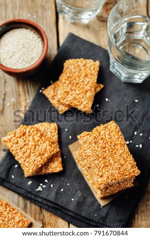 Honey sesame seed bars on a wood background. toning. selective focus 