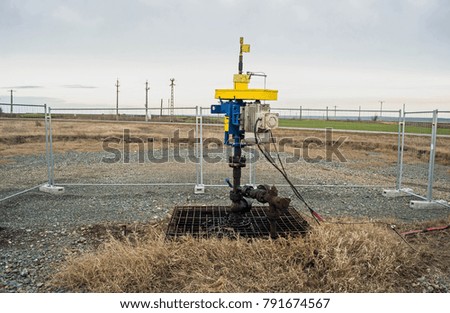 Modern oil pump on a field. Industrial equipment for gas or petrol