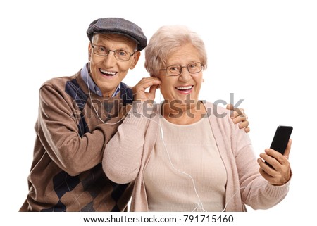 Senior couple listening to music on a phone isolated on white background
