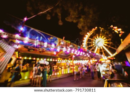 Children's Carousel at an amusement park in the evening and night illumination. amusement park at night. amusement park, picture for the background. vintage photo processing / black and white photo