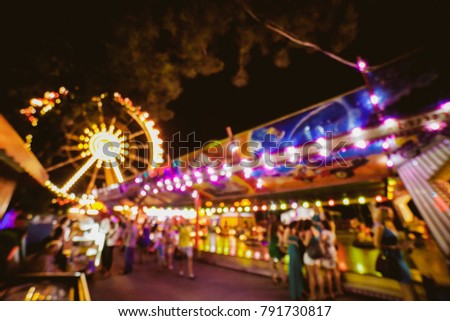 Children's Carousel at an amusement park in the evening and night illumination. amusement park at night. amusement park, picture for the background. vintage photo processing / black and white photo