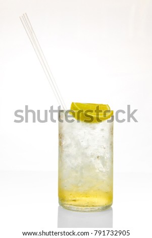 Glass of cocktail with ice and lemon isolated on white background, with reflection