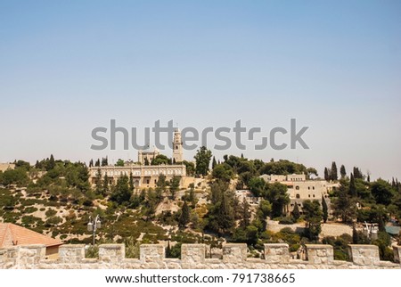 Horizontal picture of huge church on the top of hill with local vegetation in Jerusalem, Israel