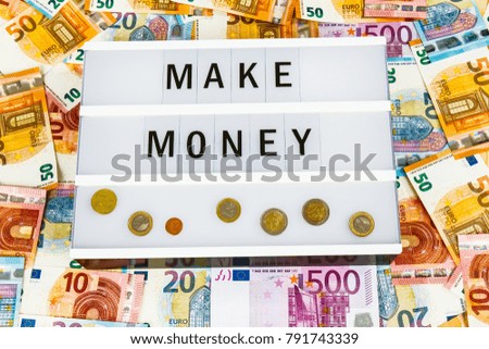 Text  Make Money written on lightbox surrounded with Euro Banknotes