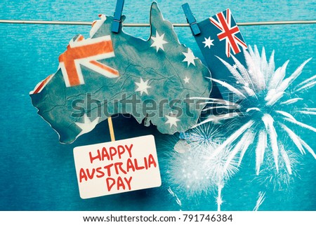 Celebrate Australia-Day holiday on January 26 with a Happy Australia Day message greeting written card across Australian maps and flag hanging pegs on blue background. 