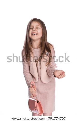 Very emotional little girl in fashion dress on white background