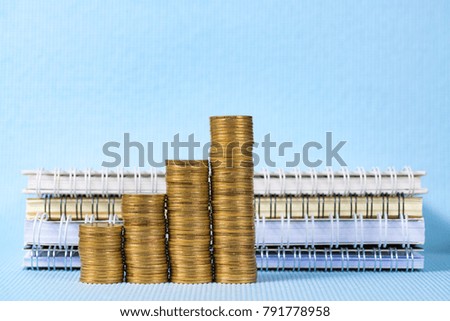 Step of coins stack and notebook paper with copy space for add text, financial and business planning concept idea.