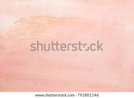 Beautiful faded pink abstract painted paper background texture with shiny metallic golden brush stroke