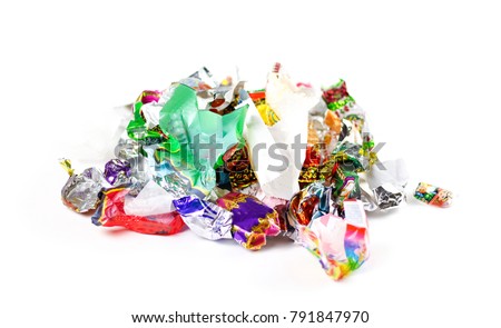 A bunch of candy wrappers on a white background. Closeup. Royalty-Free Stock Photo #791847970