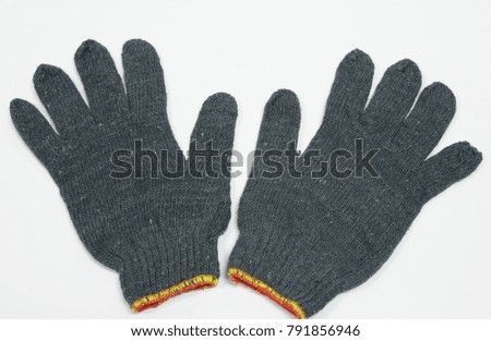 Black woven gloves placed on a white table. Wait staff to use in the factory.