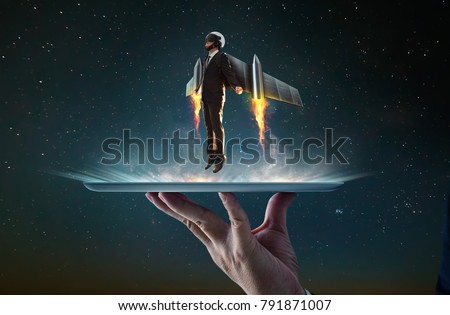 Waiter hand holding an empty digital tablet with Businessman wear a rocket suit to lift , Business success concept . Royalty-Free Stock Photo #791871007