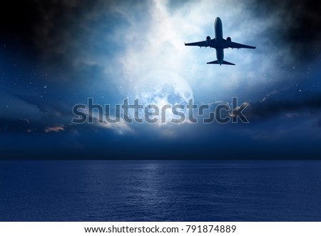 Night sky with moon in the clouds with airplane Elements of this image furnished by NASA