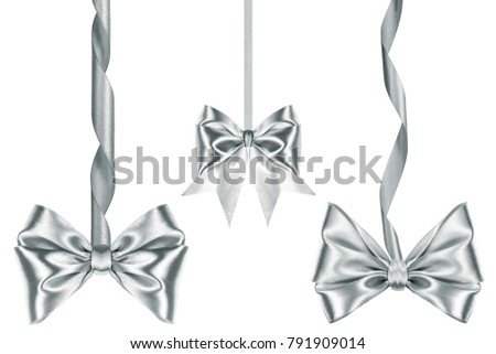 Three Beautiful satin silver ribbon bows with ribbons in different sizes over white background