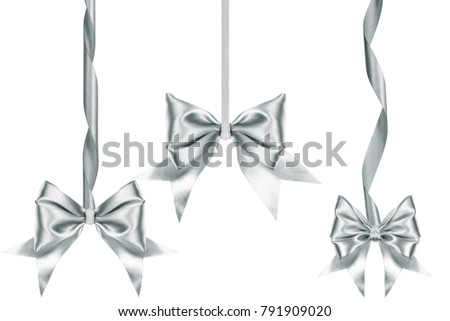 Three Nice satin silver ribbon bows with ribbons in different sizes over white background