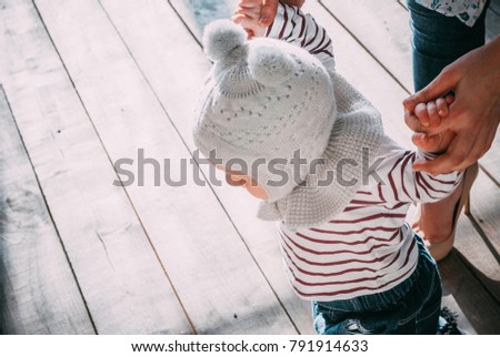 a small child is taught to walk