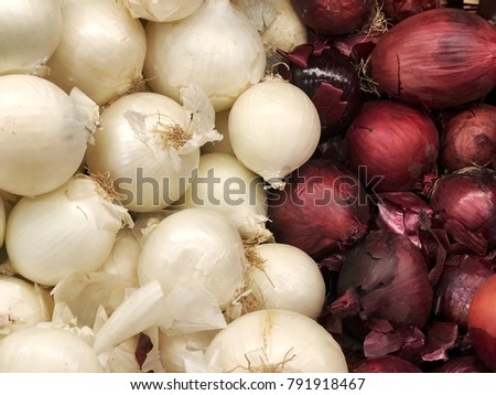 white and red onions next to each other. Picture was taken at a market.