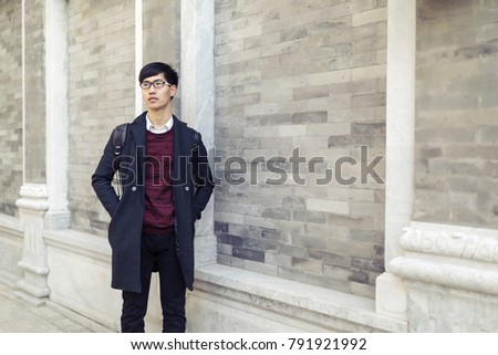 Young Asian men travel in the business district