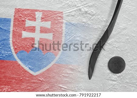 Hockey puck, stick and the image of the Slovak flag on the ice. Concept, hockey
