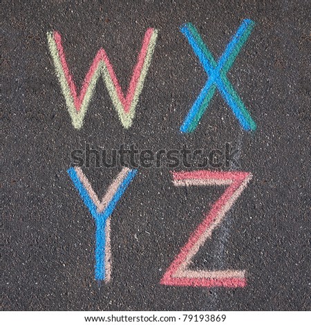 Alphabet letters drawn on asphalt with chalk, w, x, y, z