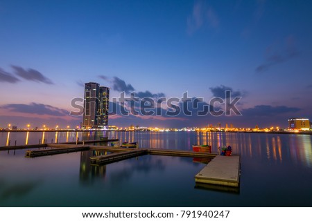 Ras Al Khaimah by night. View to beautiful bay with harbour in background Royalty-Free Stock Photo #791940247