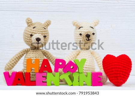 Sweet couple teddy bear doll in love with valentine text and red knitting heart on white wooden background and copy space for add text and picture, love and valentine day concept idea.