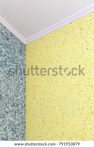 A qualitative transition from blue to yellow liquid wallpaper in the corner of the room