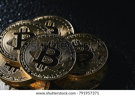 Golden bitcoin coin on the black background.