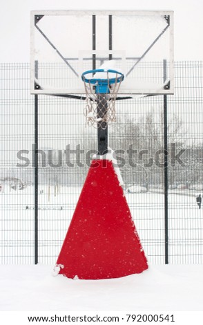 Basketball court cover with snow during a blizzard