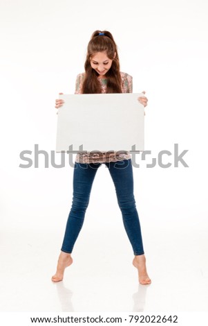 A slender girl with long hair poses with a white sign. To place a logo, emblem, advertising. Photo on a white background for advertising