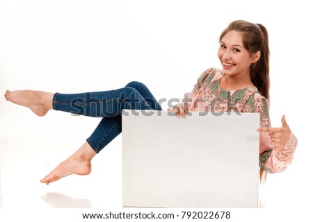 A slender girl with long hair poses with a white sign. To place a logo, emblem, advertising. Photo on a white background for advertising