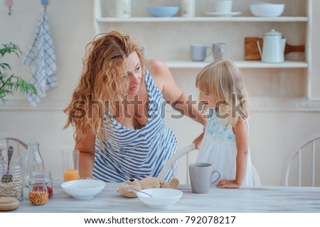 Mom and daughter having breakfast, my mother asks something about her daughter / concept of relationship with her daughters
