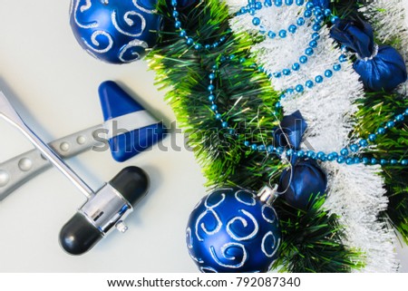 New Year and Christmas in the office of a neurologist, neurosurgeon or neuroscientist. Two neurological hammer lying next to a Christmas tree decoration 