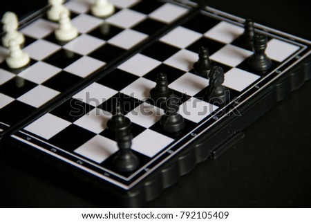 Chess and chess board on a black background.