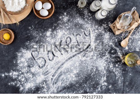 top view of bakery lettering made of flour and various ingredients for baking on dark surface