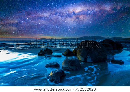 Beach rock with milkyway background at Moeraki Boulders, New Zealand. 