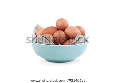 Isolated farm fresh organic brown chicken eggs from free range chickens in a blue bowl over a white background with light shadow. Clipping path included.