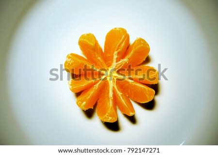 slices of a tangerine looks like open flower.