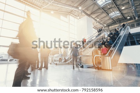 crowd of business people rushing at escalators