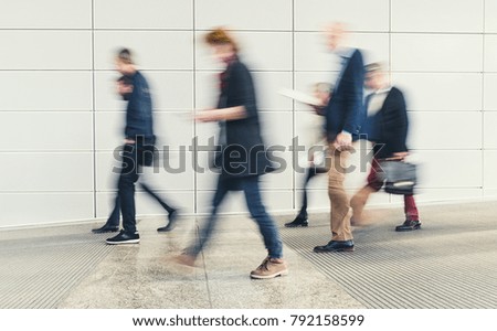 abstract blurred people walking in a corridor