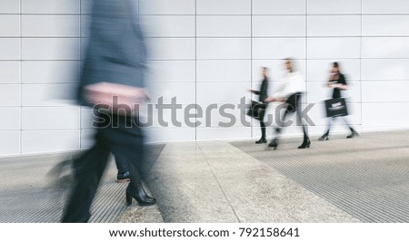 Blurred business people walking