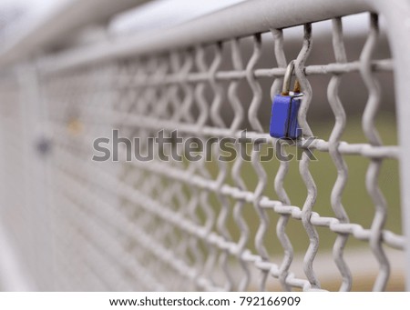 A blue love padlock locked to a bridge, Vienna Austria