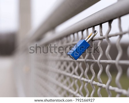 A blue love padlock locked to a bridge, Vienna Austria