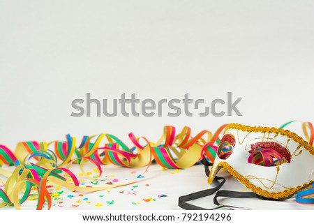 Carneval background with mask, confetti and garland