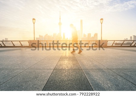 Running man  training outside in shanghai with skyline in sunrise
