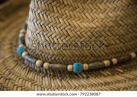 Close up straw cowboy hat with beads angle shot of brim ponderosa background texture